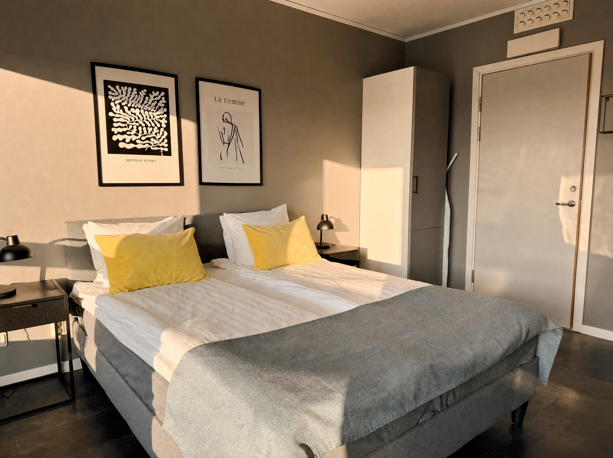 Bedroom with double bed, framed art and city view